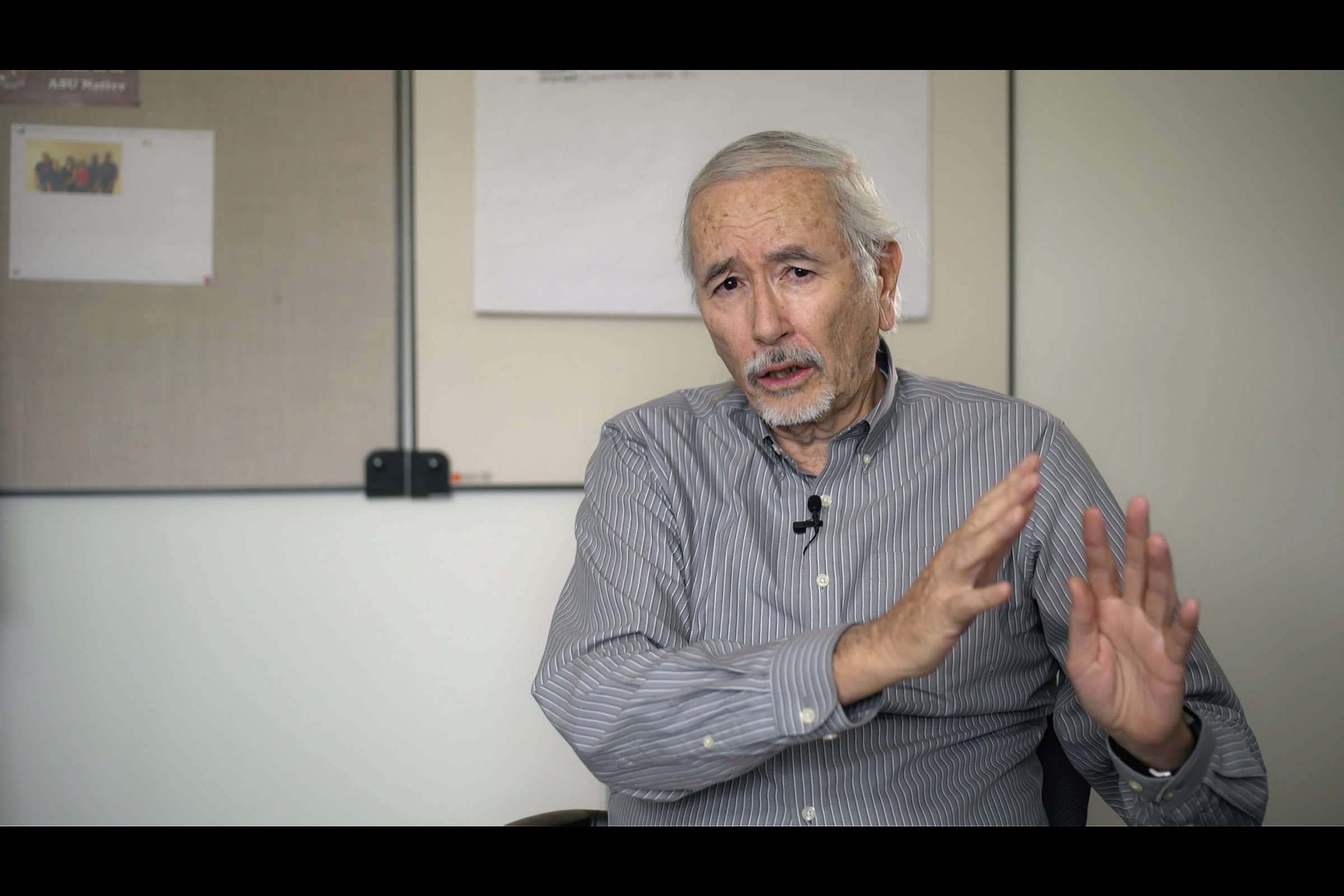 Man sitting in an office space, talking