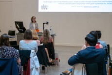 Maria Teschler-Nicola speaking at the Dead Images Conference, Edinburgh College of Art, July 2018. Woman standing and talking to an audience in an event hall.