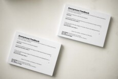 Two piles of identical cards on a white surface. The title reads 'Anonymous Feedback'. Underneath it a set of questions about the Dead Images exhibition