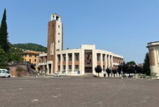 Former House of the Fascist Party in Predappio, Italy, June 2025. Large modernist building with a tower, some of the windows are broken.