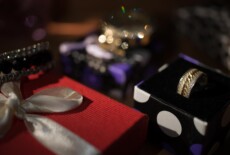 Ring inside jewellery box next to other out of focus boxes and jewlery.